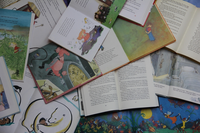 Children's books laying open on a surface