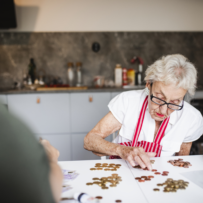 Eldre dame som teller penger