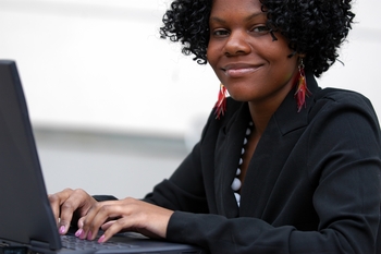 Woman smiling by computer