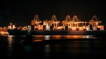 A cargo ship in dark waters at night